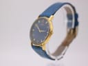 Angled side view of the Citizen watch, highlighting the gold-tone case, crown, and blue strap.