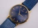 Close-up front view of the Citizen watch dial, showing the deep blue face, gold Arabic numerals, baton indices, and hands.