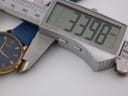 Digital caliper measuring the watch case diameter from a slightly different angle, displaying 33.98mm.