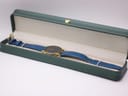 The Citizen watch presented open in a green display box.