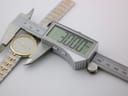 Overhead view of the watch being measured by a digital caliper, displaying 30.00mm case diameter.