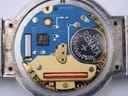 Close-up of the open case back revealing the Swiss ETA 955.412 7 jewels quartz movement with battery.