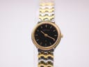 Front view of Certina ladies watch, black dial with gold tone markers, two-tone gold and silver bracelet.