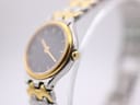Angled side view of the Certina watch, showing the gold tone crown and case bezel detail.