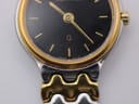 Extreme close-up of the Certina watch dial showing the gold markers, hands, 'CERTINA' logo and 'SWISS MADE' text.