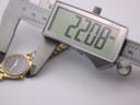 Close-up of digital caliper showing case diameter measurement of 22.08mm on the Certina watch.