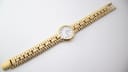 Top-down view of the full length of the gold Raymond Weil 9954 watch and bracelet.