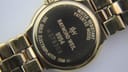 Close-up of the case back of the Raymond Weil 9954, showing model, serial, and '18K gold electroplated'.