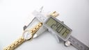 Digital caliper measuring the case diameter of the Raymond Weil 9954 at 24.01mm.