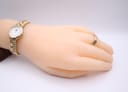Raymond Weil 9954 watch displayed on a mannequin hand with a gold ring.