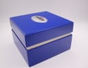 A top-down view of the original Tissot blue presentation box with the Tissot logo prominently displayed on the lid.