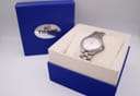 The Tissot T660 watch resting in its original blue presentation box, which features the Tissot logo.
