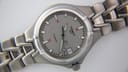 Macro close-up of the Tissot T660 watch dial, highlighting the 'TITANIUM', '200 M / 660 FT' text, date window, and hour markers.