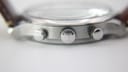 Close-up of the Tissot signed crown and two rounded chronograph pushers on the side of the watch case.