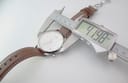 Digital caliper measuring the case diameter of the Tissot watch, displaying a reading of 41.19mm.