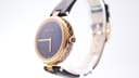 Side profile of the Gucci watch, showcasing the distinctive patterned case band and crown.