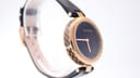 Another side profile view of the Gucci watch, focusing on the case design and black leather strap.