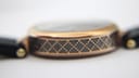 Close-up showing the patterned side of the Gucci watch case, with subtle signs of wear on the rose gold finish.