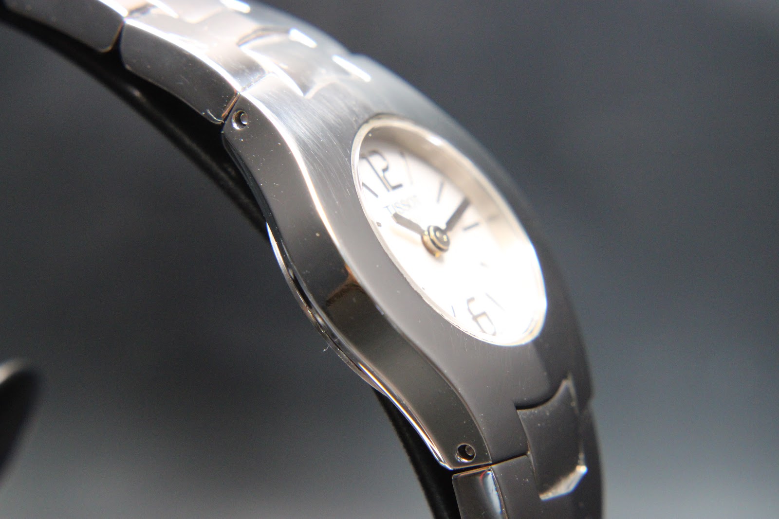 Angled close-up of the watch case and bracelet connection, highlighting the brushed and polished stainless steel finishes.