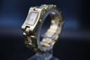 Front-right three-quarter view of the Gucci 2305L ladies gold-tone rectangular watch showing the champagne dial and integrated bracelet.