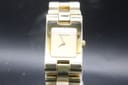Front view of Gucci 2305L gold-tone watch with rectangular champagne dial, GUCCI branding at 12 o'clock, and integrated bracelet.