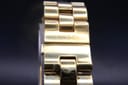 Close-up of the Gucci 2305L integrated bracelet's hidden deployant clasp area with etched 'GUCCI' signature.