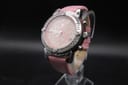 Angled front view of the Façonnable pink dial chronograph watch on a stand, showcasing the crystal-set bezel and pink leather strap.