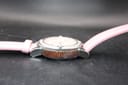Opposite side view of the watch case, showing the textured brown mid-case and lug design.