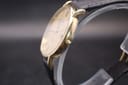 Side profile view of the Longines Présence watch, highlighting its ultra-slim gold-tone case and crown.