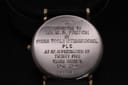Close-up of the stainless steel case back, showing the dedication engraving from Hydra Tools International PLC and the watch serial number.