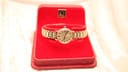 Front view of the Omega Geneve watch presented in its original red Omega branded box.