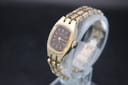 Angled view of gold-tone Seiko 11-3520 on display stand, showing brown dial and textured bracelet.