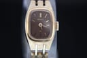 Front view of gold-tone Seiko 11-3520 watch, showing rectangular brown dial with gold baton indices.