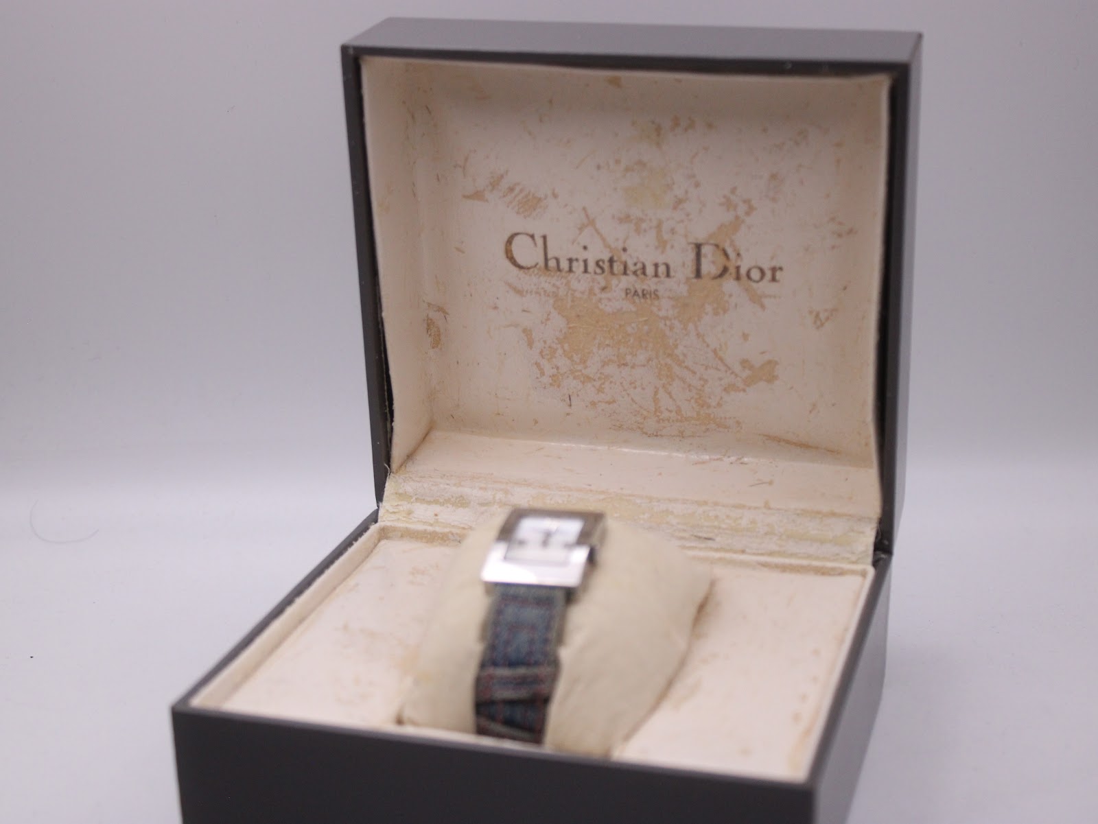 Christian Dior D78-109 watch presented within its original black box, showing interior wear.