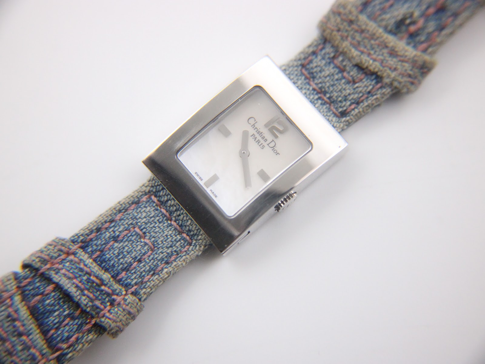 Angled front view of the Christian Dior D78-109 watch, showcasing the dial and the blue fabric strap.