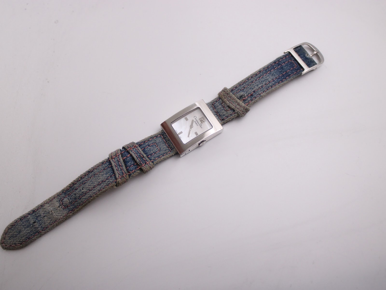 Full length overhead view of the Christian Dior D78-109 watch, displaying the entire blue fabric strap from the front.