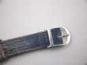Close-up of the polished silver-tone buckle, clearly showing the engraved 'D' Christian Dior logo.