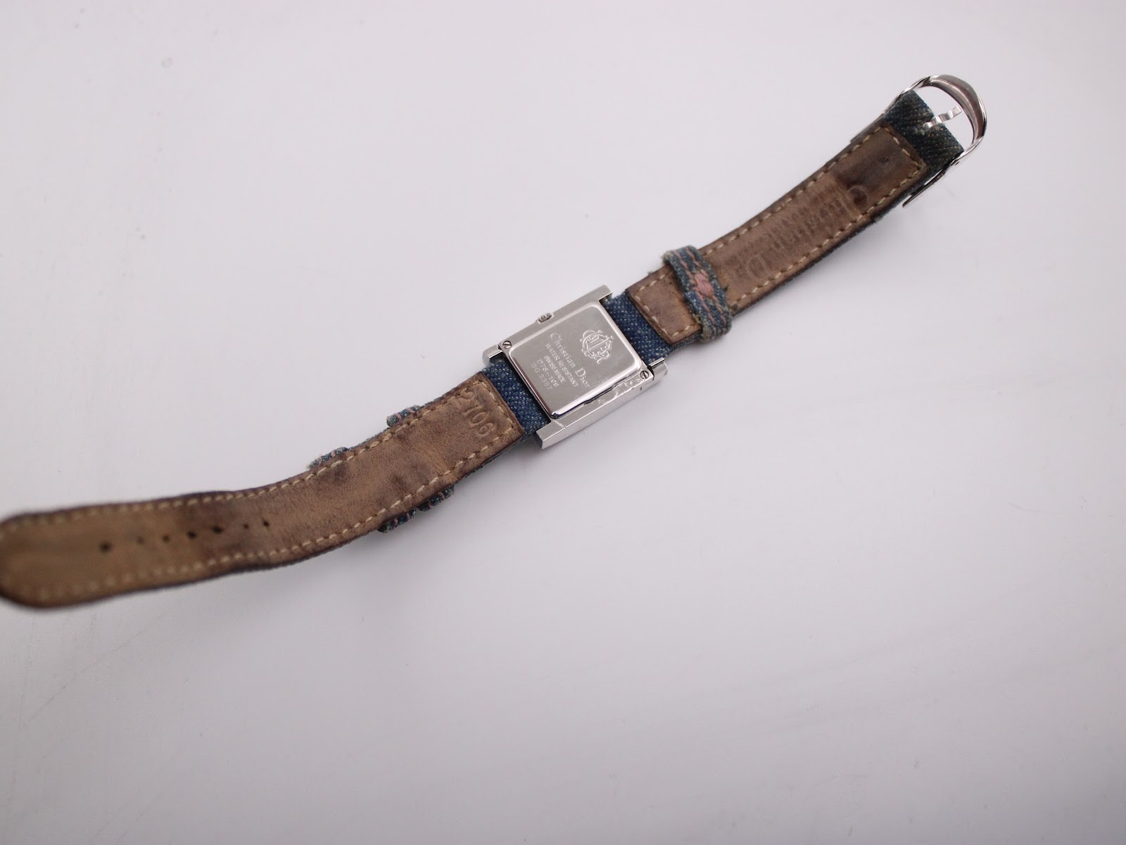 Full length overhead view of the Christian Dior D78-109 watch from the rear, showing the worn brown leather lining of the strap.