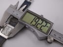 Digital caliper measuring the case width of the Christian Dior D78-109 watch, displaying a precise reading of 19.22mm.
