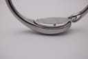 Close-up of the watch's left side, showing the smooth, polished stainless steel case and bangle curves.