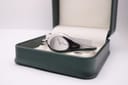 Front-facing view of the Gucci 103 watch resting inside a dark green presentation box, highlighting the dial.