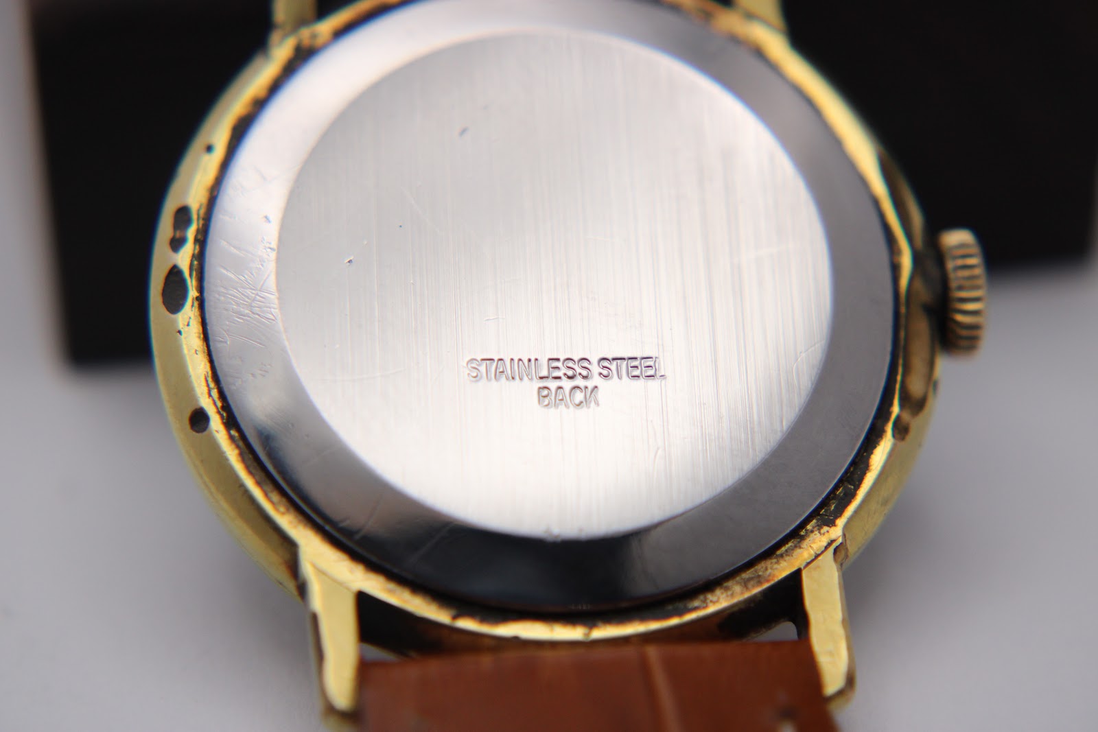 Close-up of the polished stainless steel case back of the Magna watch, with 'STAINLESS STEEL BACK' engraved in the centre.