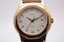 Close-up front view of the Tissot PRX P340-G dial, showing the intricate texture, gold hands, and date window at 3 o'clock.