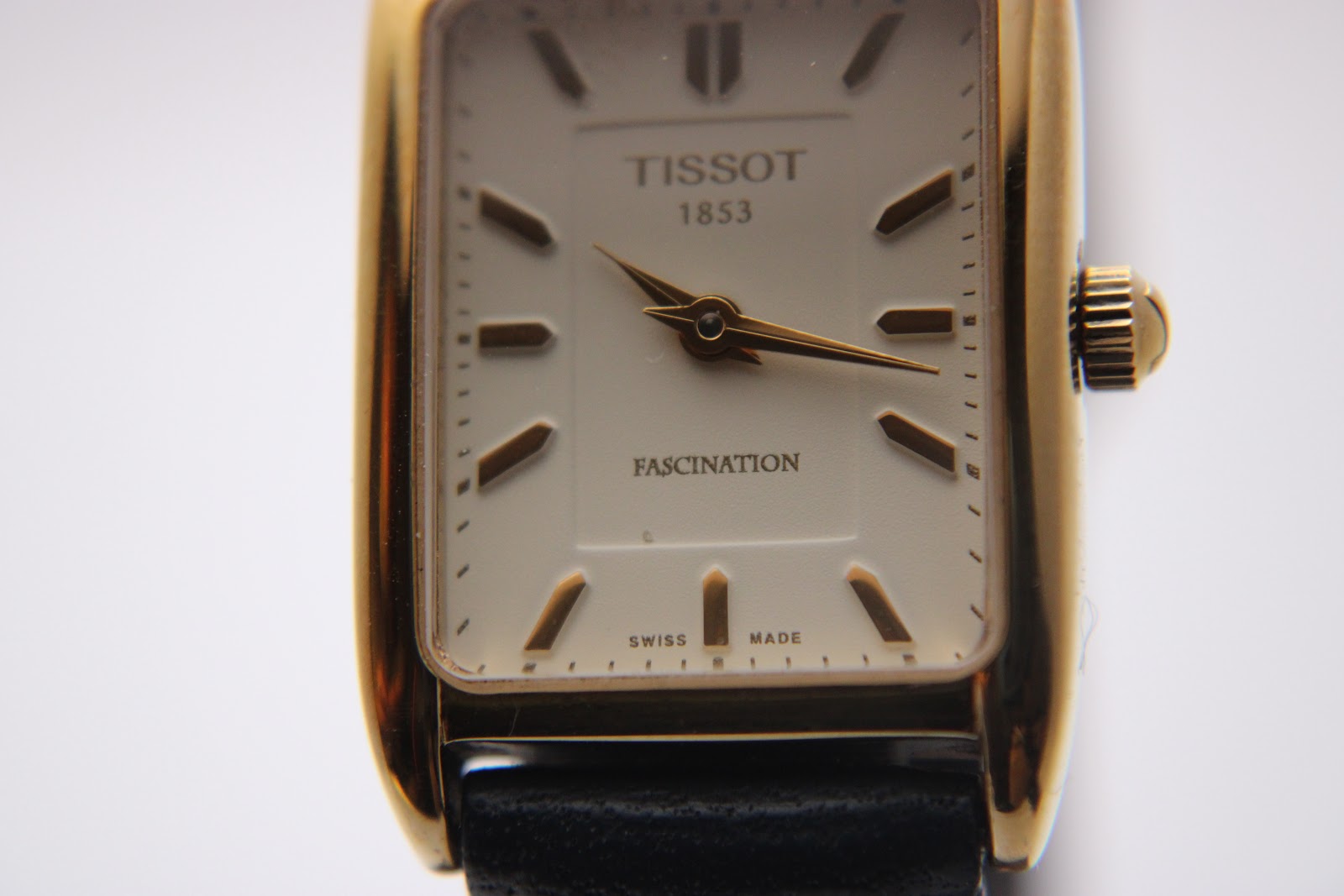 Detailed close-up of the Tissot T815 Fascination dial, showing 'TISSOT 1853' and 'FASCINATION' text, with gold hands.