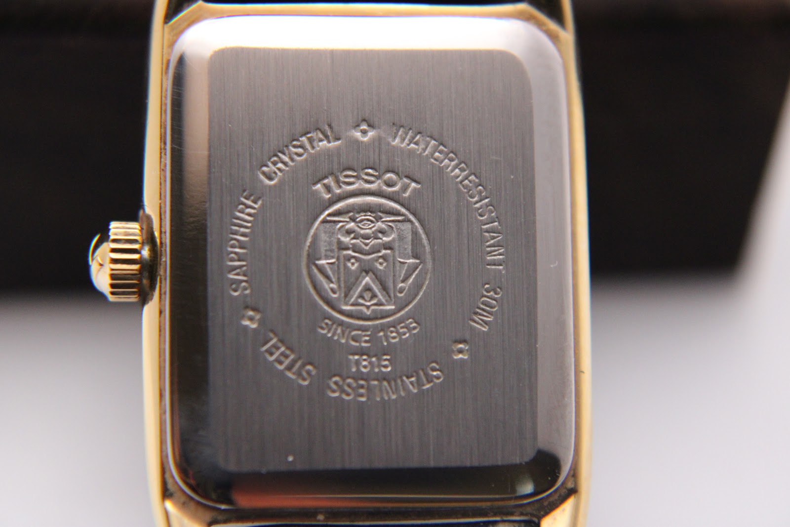 Rear view of the Tissot watch, showing the stainless steel case back with 'TISSOT', 'SAPPHIRE CRYSTAL', 'WATERRESISTANT 30M', 'STAINLESS STEEL', and model 'T815' engravings.