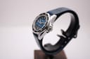 Side profile of the Marine Star watch on a dark display stand, highlighting the polished stainless steel case and crown.