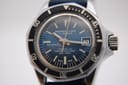 Close-up of the Marine Star blue sunburst dial, featuring luminous indices, hands, date window, and "600 FEET" water resistance text.