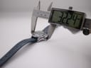 Digital caliper measuring the watch case including the crown, displaying a measurement of 32.24mm.