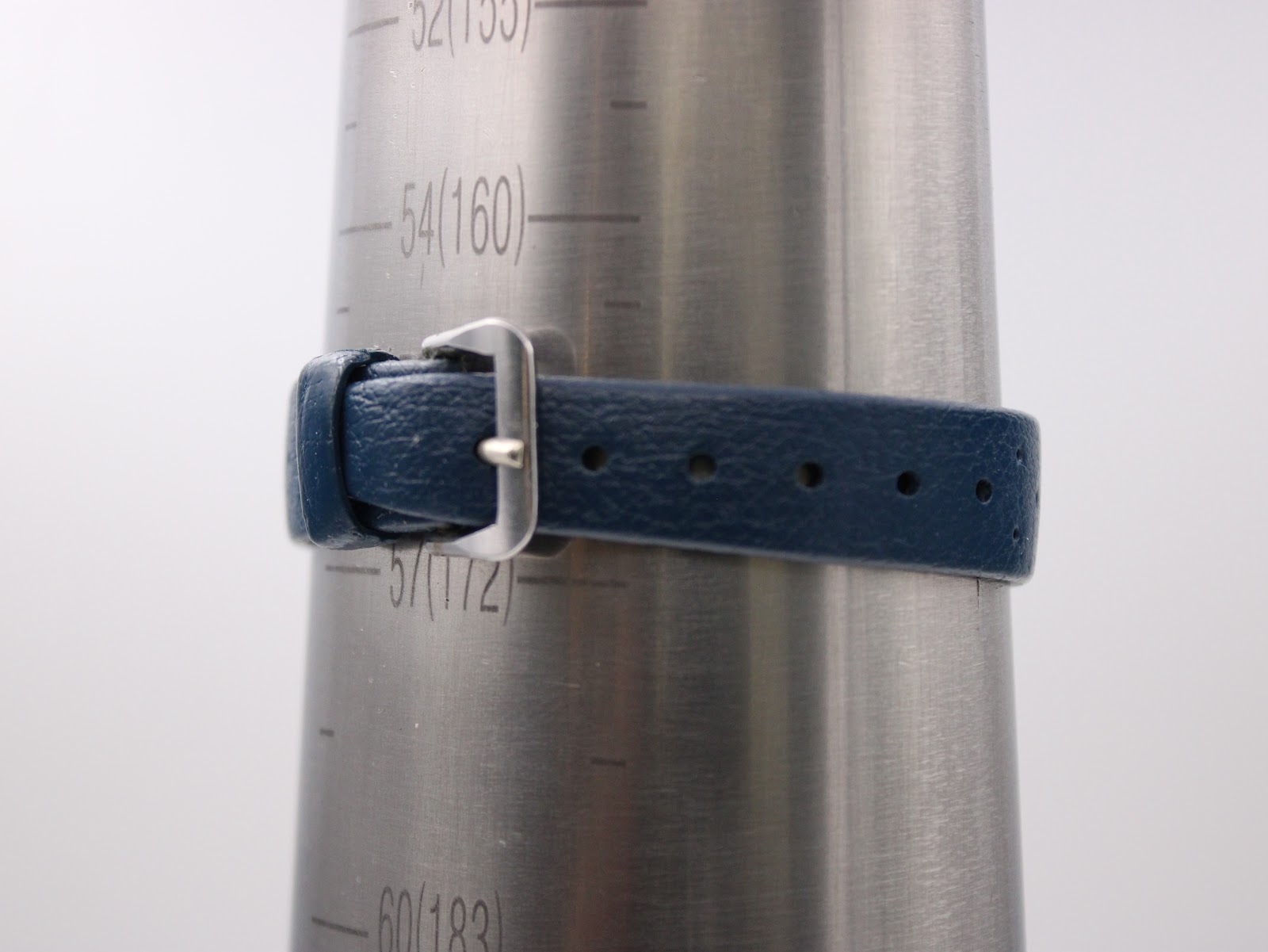 Close-up of the dark blue rubber strap on a wrist sizing cone, showing it buckled at approximately 155mm / 15.5cm.
