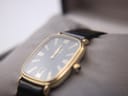 Angled view of the Dunhill watch in its original box, focusing on the dial and crystal with visible hairline scratches.